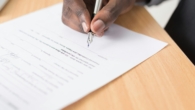 person writing on white paper