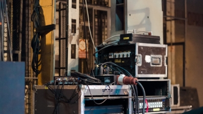 black and gray amplifier beside white and black surface